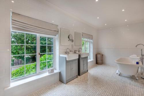 a white bathroom with a tub and a sink and a bath tub at 4 Bed in Bray oc-b32610 in Bray