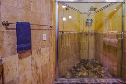 a bathroom with a shower with a blue towel at Stylish Apartment Upscale Chapultepec District in Tijuana