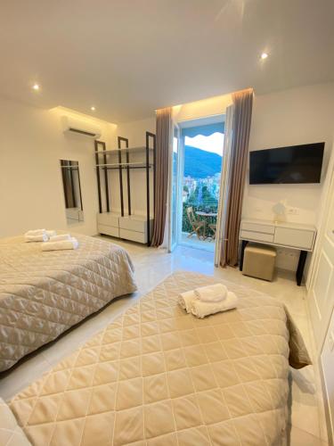 a bedroom with two beds and a large window at Affittacamere Sulle Stelle in La Spezia