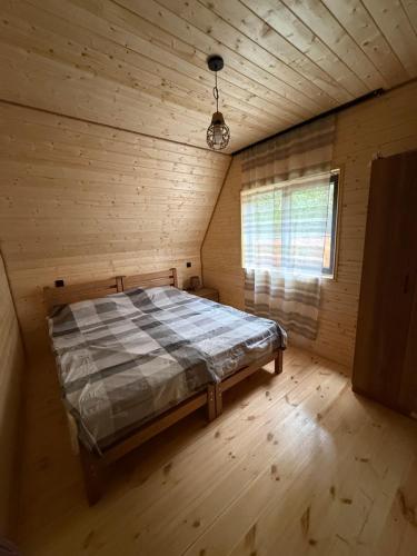 a bedroom with a bed in a wooden room at Glola A-Frame Cottages in Glola