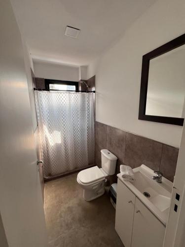 a bathroom with a toilet and a sink at DOCTA Residencia in Córdoba