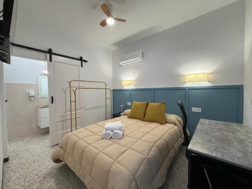 a bedroom with a bed with two towels on it at Casita Machado in Úbeda