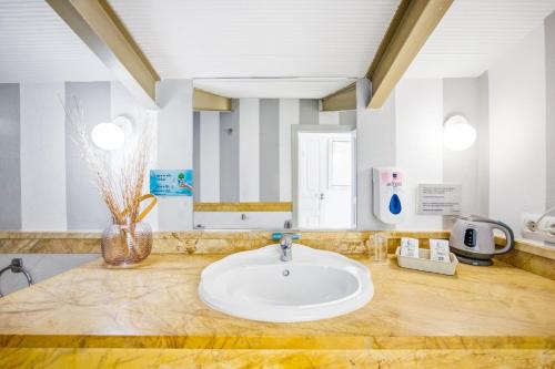 a bathroom with a sink and a mirror at Labreña Hotel in Los Caños de Meca