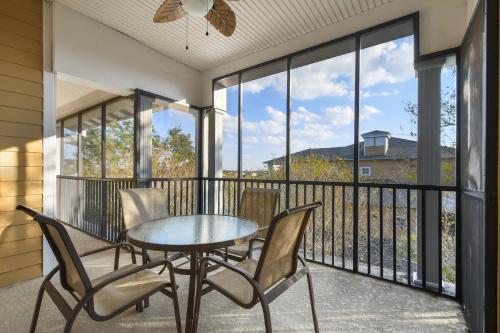 a patio with a table and chairs on a balcony at Bahama Bay Huge Penthouse condo in Kissimmee