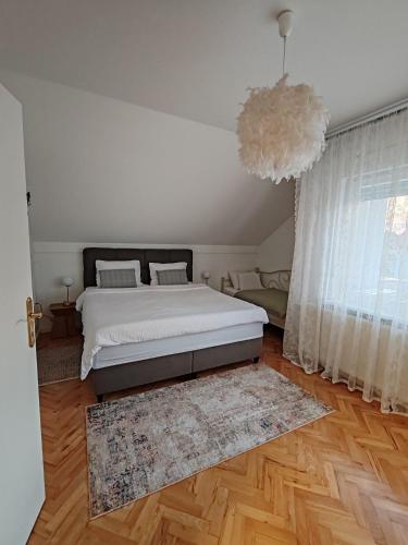 a bedroom with a bed and a large window at U prolazu in Đakovo