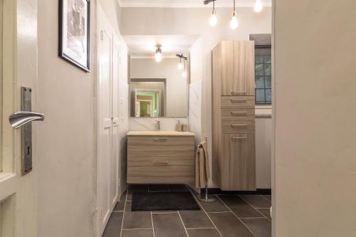 a bathroom with a sink and a mirror at La Quiete del Mattino in Torre Pellice