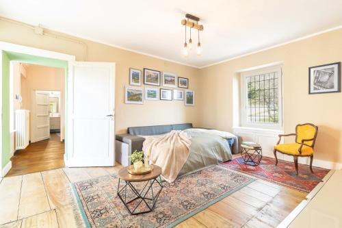 a bedroom with a bed and a table and a chair at La Quiete del Mattino in Torre Pellice