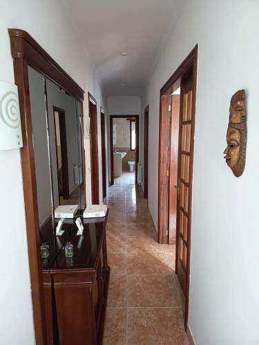 a hallway with a vanity and a mirror in a room at Casa en vigo in Vigo
