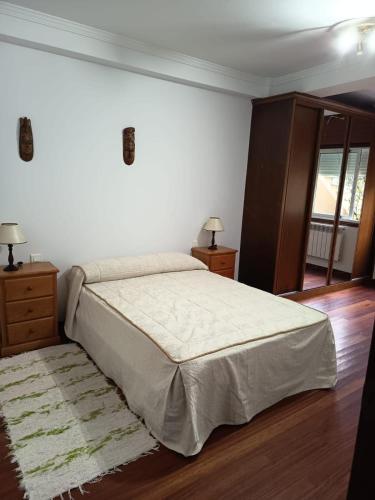 a bedroom with a large bed and two night stands at Casa en vigo in Vigo