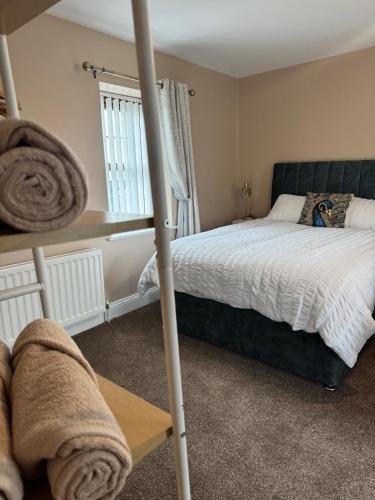 a bedroom with a bed and a window at Dessie's in Magherasaul