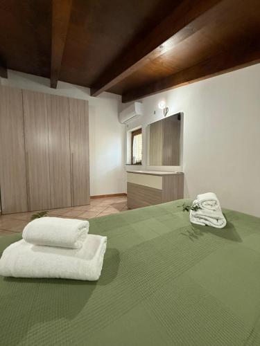 a bedroom with two white towels on a bed at Villa Degli Ulivi in Furore