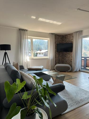 a living room with a couch and a table at Ferienwohnung Bergidyll in Schönau am Königssee