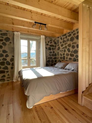 a bedroom with a bed in a room with a window at Abri Tiny House in Murat