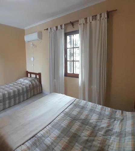 a bedroom with two beds and a window at Temporario Elisa in Santa Fe