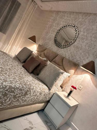 a bedroom with a bed and a side table at Lux Appartement Dahomy Beach in Bouznika