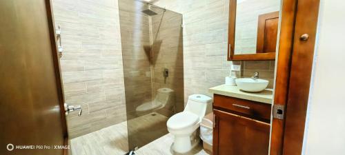a bathroom with a shower and a toilet and a sink at Casa el Corral #2 in Aguacate