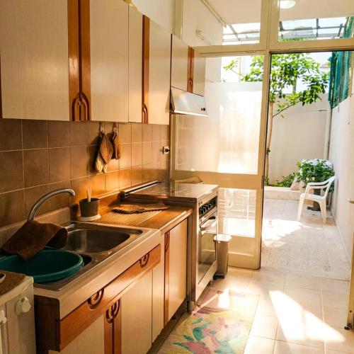 a kitchen with a sink and a stove at Casa Aloe by My Home Apulia in Torre Lapillo