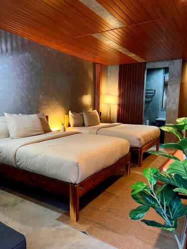 two beds in a hotel room with at Island Pod in El Nido