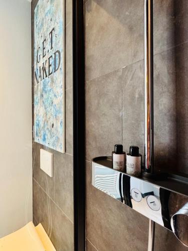 a bathroom with a shelf with two glasses on it at DinLoft in Dinant