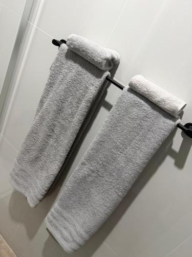 two towels hanging on a towel rack in a bathroom at Ocean Palm Apartments II - Edifício Paradis- Cidadela in Praia