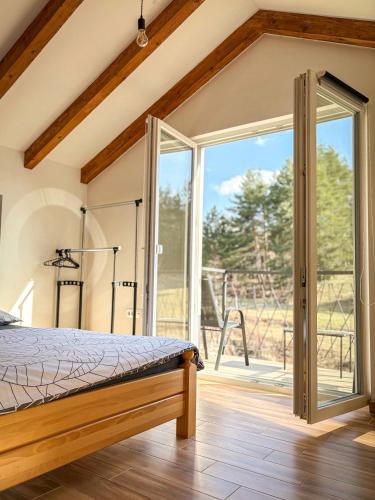 a bedroom with a bed and a sliding glass door at Villa Marija in Livno