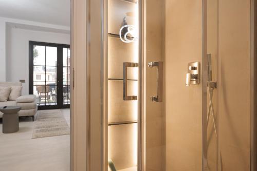 a door to a room with a living room at Poolside and Garden Apartments Golem Beach in Golem