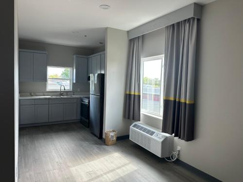 a kitchen with a refrigerator and a sink and a window at Super 8 by Wyndham Baytown in Baytown