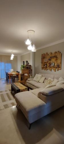 a large room with four beds and a dining room at Apartamento Acogedor con Mucha Luz in Brenes