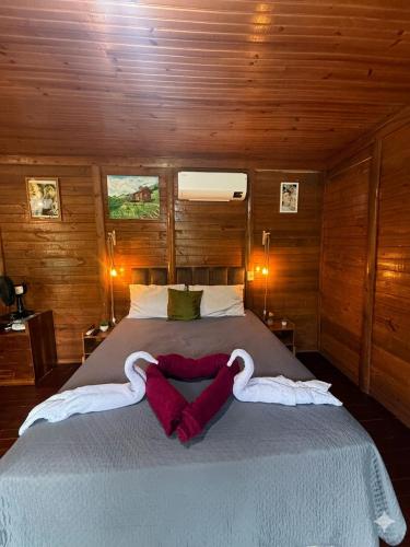 a bedroom with a large bed with two swans towels at Loft do Lessa in Ouro Preto