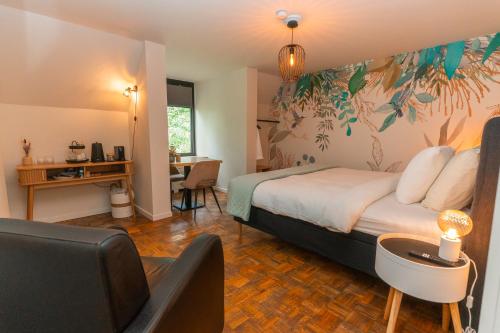 a bedroom with a bed and a desk and a chair at Charme logies Kampernoelie in Hoeselt