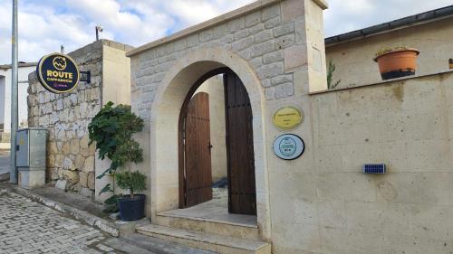 a building with a door and a clock on it at Route Cappadocia in Avanos