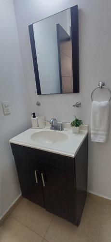 a bathroom with a sink and a mirror at Condo Sunset in Cabo San Lucas