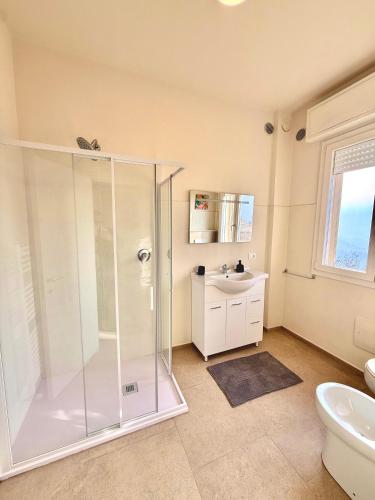 a bathroom with a shower and a sink at B&B Il COTOGNO - Cucina e Parcheggio Privato in Serramazzoni