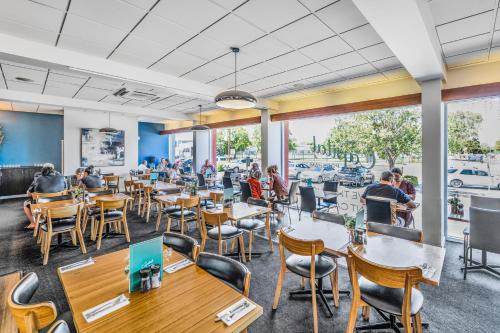 a restaurant with people sitting at tables in a cafeteria at The Capital Horsham in Horsham