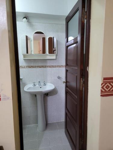 a bathroom with a sink and a mirror at Tia Clara in San Salvador de Jujuy