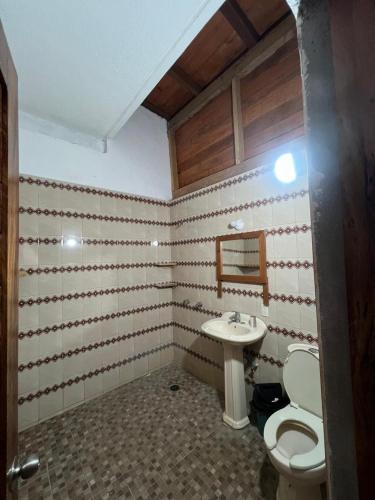 a bathroom with a toilet and a sink at Casa Esmeralda in La Huerta