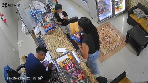 a group of people standing around a counter in a store at Hotel Cotopaxi in El Coca