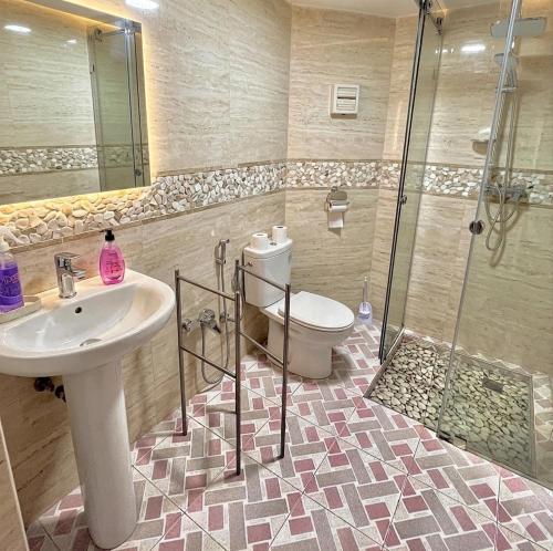 a bathroom with a toilet and a sink and a shower at Marrakech home in Marrakesh