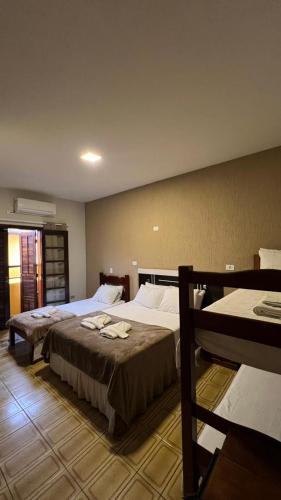 a hotel room with two beds in a room at Pousada Mar de Ubatuba - Itaguá in Ubatuba