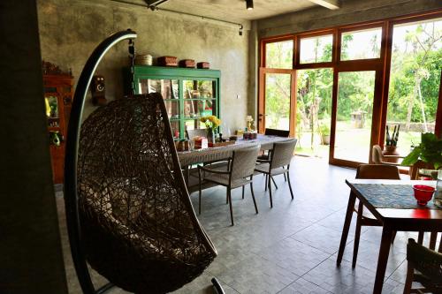 a mirror in a room with a table and chairs at Rumah Hadeka sawan in Sawan