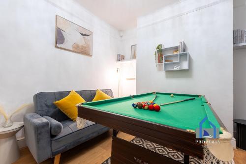 a living room with a pool table and a couch at Traditional Central Home-Games Room-Free Parking in Manchester