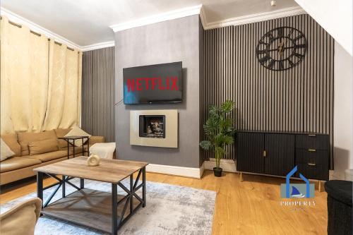 a living room with a couch and a table at Traditional Central Home-Games Room-Free Parking in Manchester