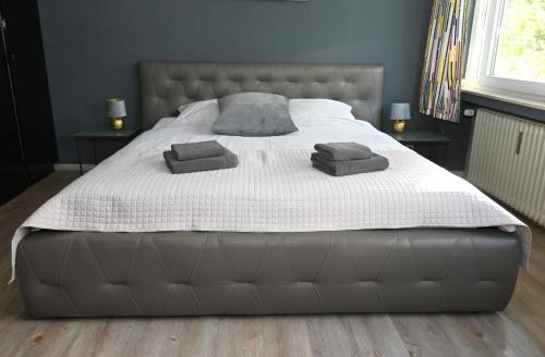 a large bed with two pillows on top of it at Villa Hortensie in Aachen