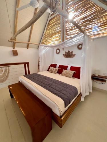 a bedroom with a bed in a room with a ceiling at Leeloo Boutique Hotel in Las Terrenas