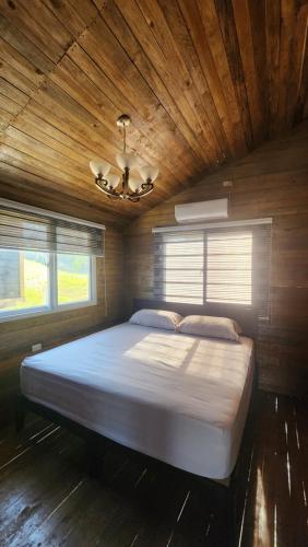 a large bed in a room with a wooden ceiling at Bunkhouse Lodge in Omoa