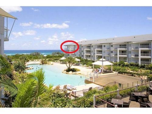a house with a swimming pool next to a resort at Salt Beach Resort Suites by Kingscliff Accommodation in Kingscliff