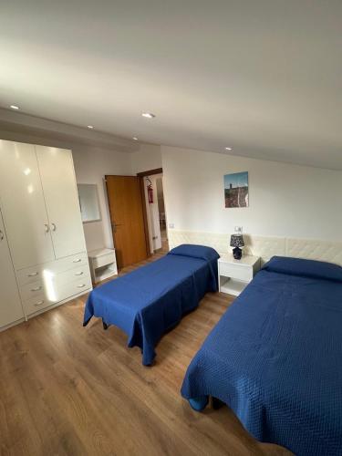 ein Schlafzimmer mit zwei Betten und einer Kommode in der Unterkunft Casa Piaggiola in Gubbio