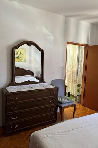 a bedroom with a dresser with a mirror on it at Apartment Vis 2436a in Vis