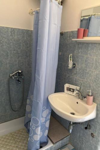 a bathroom with a shower curtain and a sink at Apartment Vis 2436a in Vis