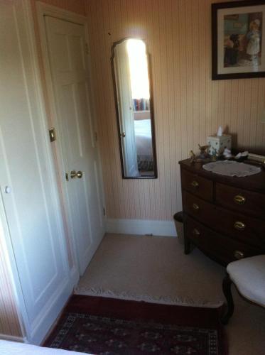 a bathroom with a sink and a dresser and a mirror at Petercott in Shepton Mallet
